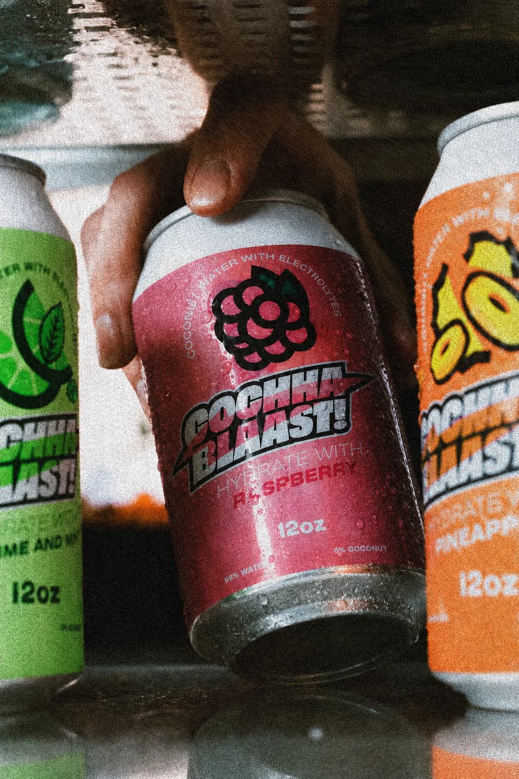 Cochaa Blaast raspberry can taken from a fridge beside the lime and pineapple cans