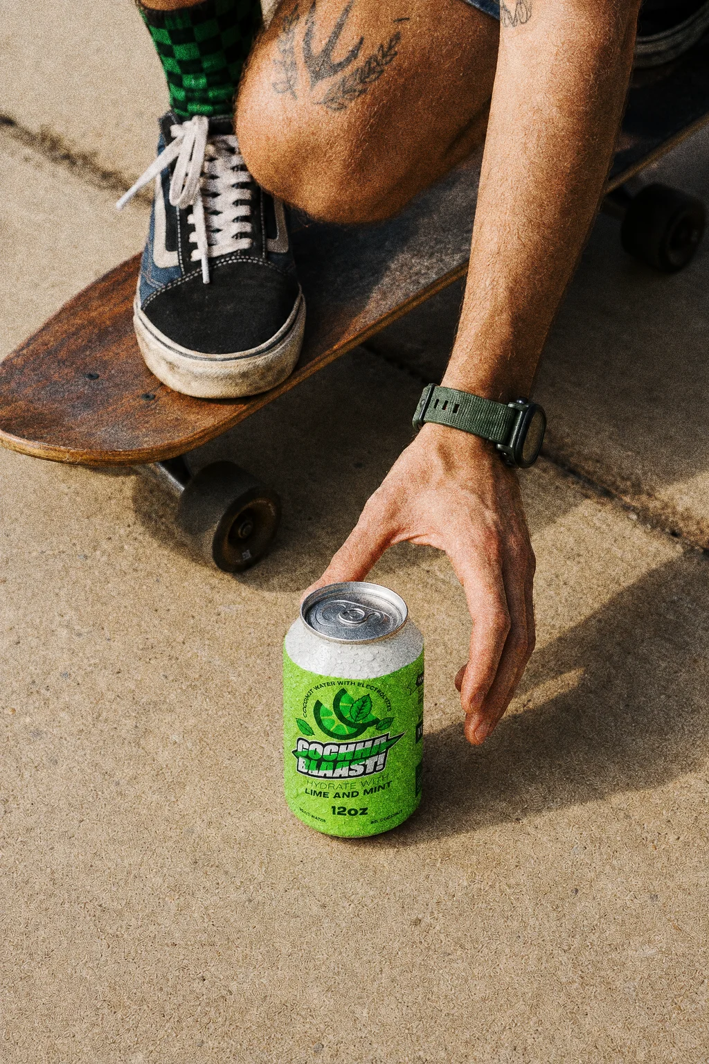 Cochaa Blaast lime and mint can on concrete beside a skateboard